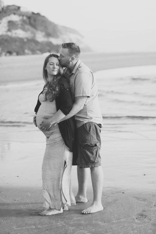 maternity photo shoot at the beach holding wifes belly maternity photo shoot at the beach holding wifes belly