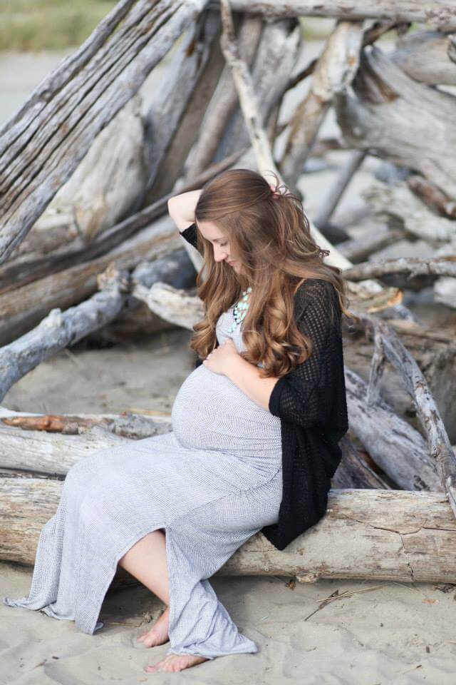 maternity photo shoot at the beach sitting on a tree maternity photo shoot at the beach sitting on a tree